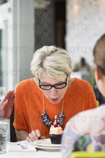 Woman celebrating birthday in restaurant