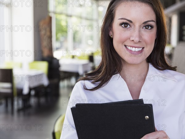 Caucasian waitress smiling in restaurant