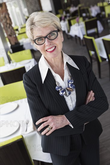 Caucasian businesswoman smiling in restaurant