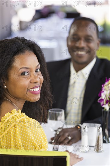 African American couple smiling in restaurant