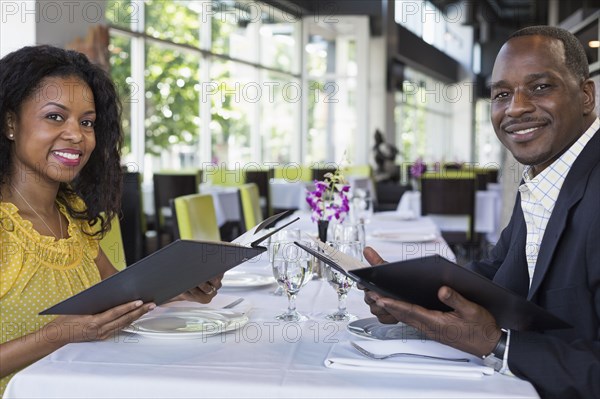 African American couple smiling in restaurant