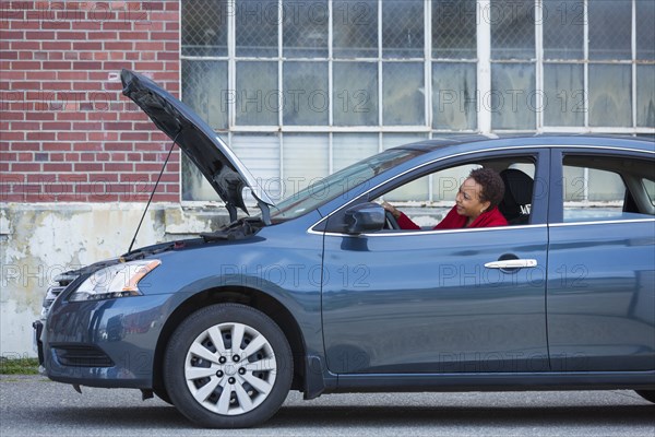 Black woman with broken down car