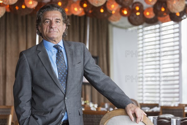 Businessman standing in dining room