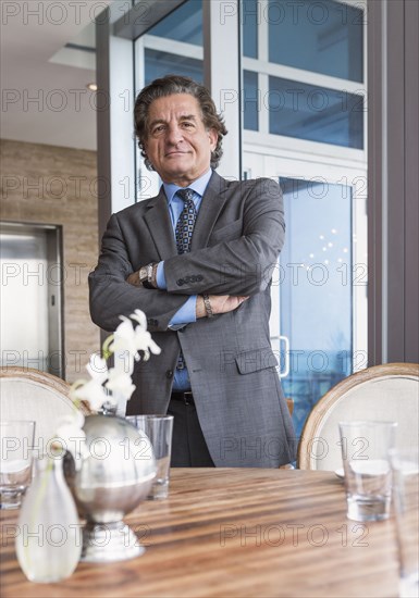 Businessman standing at dining table