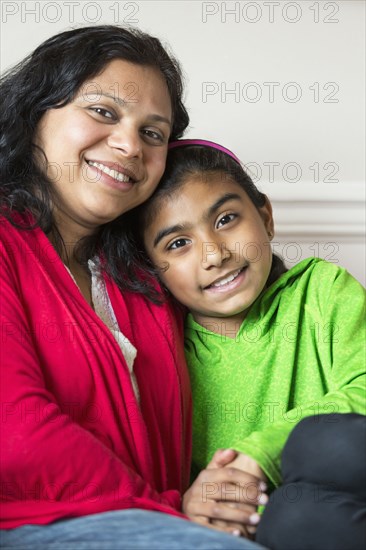 Close up of Indian mother and daughter smiling