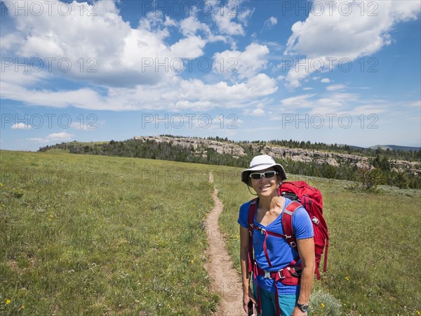 Japanese hiker smiling on dirt path