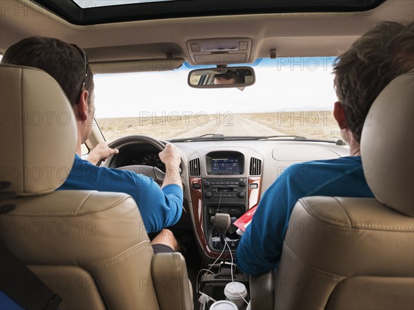 Caucasian couple driving in car