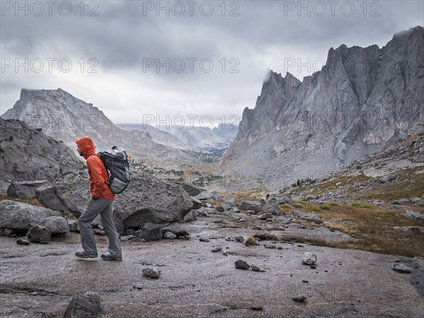 Caucasian hiker walking near mountains