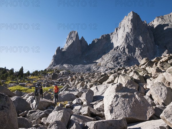 Caucasian hikers walking in rocky field