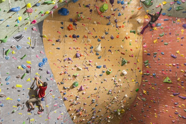 Caucasian climbers scaling rock wall