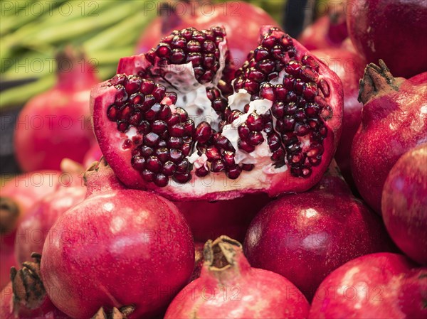 Close up of seeds in sliced pomegranate pile