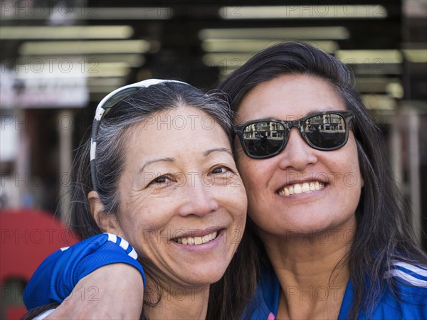 Japanese women posing cheek to cheek