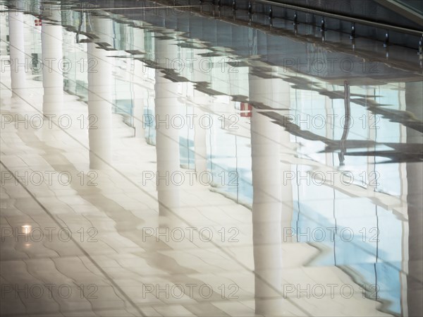 Reflection of window and pillars on shiny floor