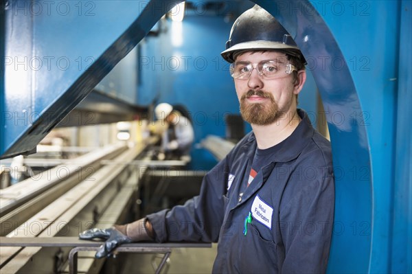 Caucasian worker posing in factory