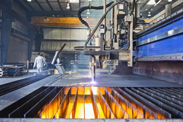 Machinery fabricating metal in factory