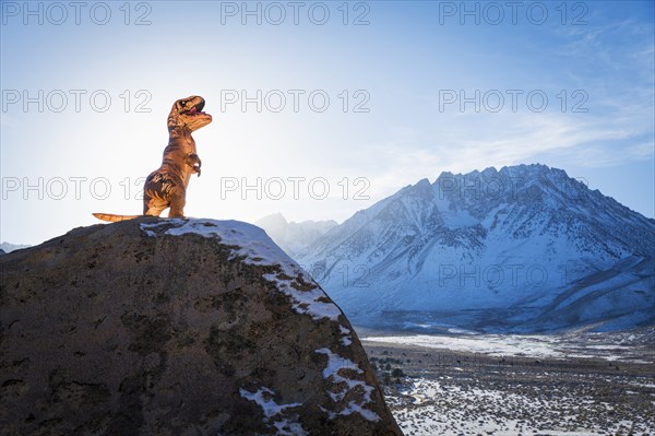 Dinosaur statue on rock