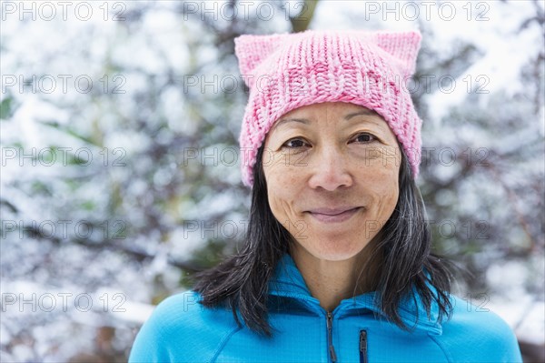 Smiling Japanese woman wearing pink hat with ears