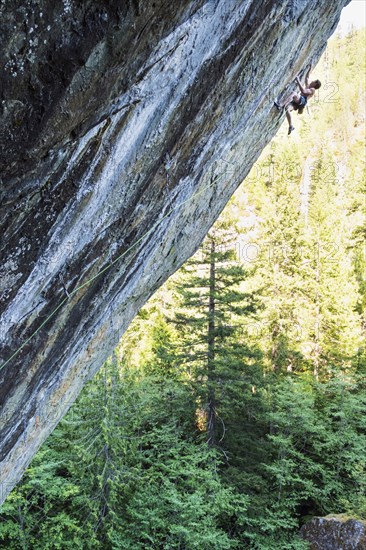 Caucasian boy climbing rock