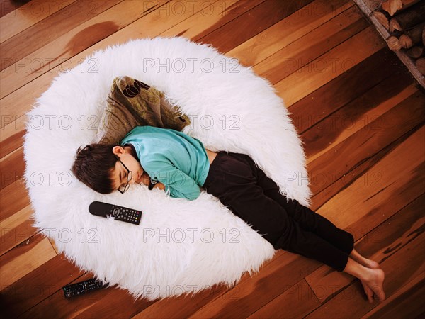 Mixed race girl napping in beanbag chair