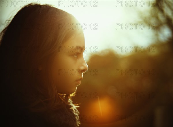 Profile of mixed race girl outdoors