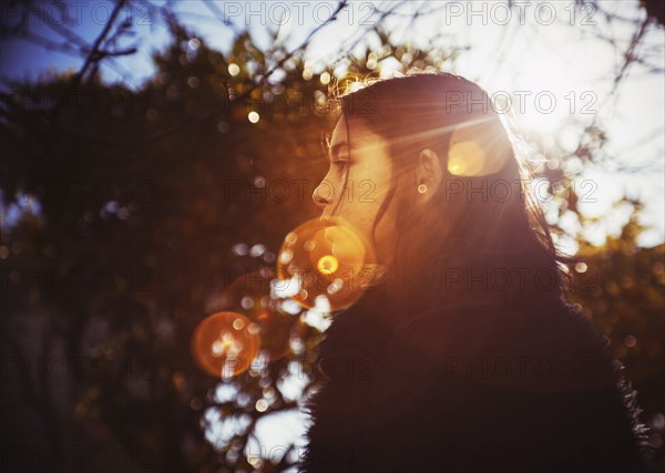 Profile of mixed race girl outdoors