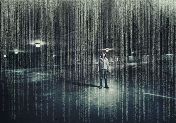 Mixed race girl standing in parking lot under raining binary code