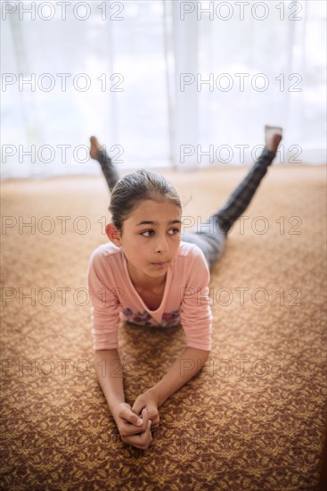 Mixed race girl laying on floor