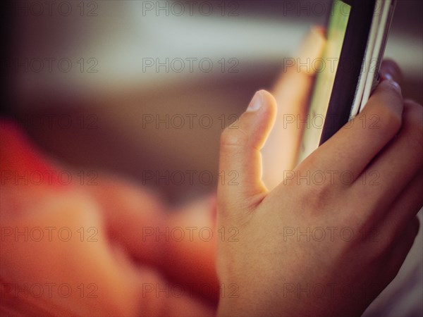 Close up of mixed race girl using cell phone