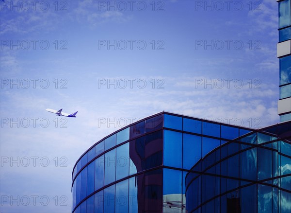 Airplane flying over airport tower