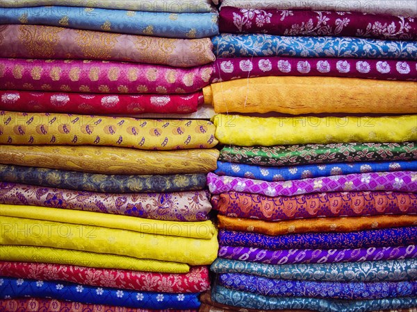 Close up of piles of multicolor fabrics