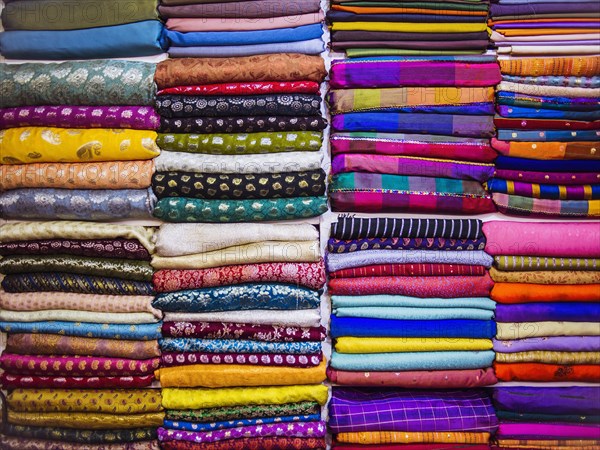 Close up of piles of multicolor fabrics