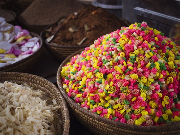 Bowls of grains and dried pasta for sale in market