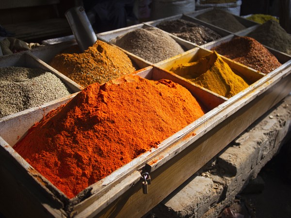 Bins of dried spices for sale in market