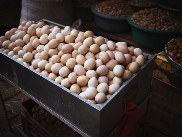 Bin of fresh eggs for sale in market