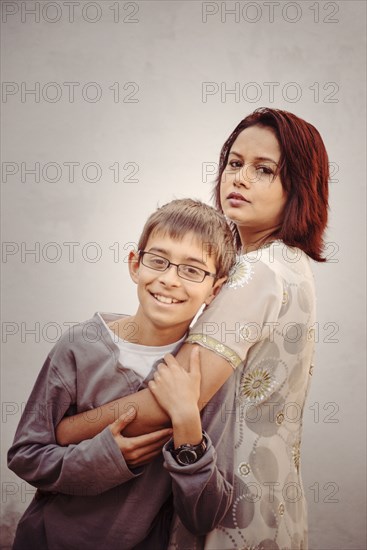 Mother and son hugging outdoors