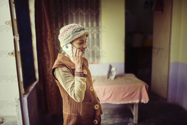 Woman in knit hat talking on cell phone