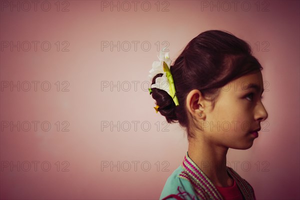 Mixed race girl wearing flowers in her hair