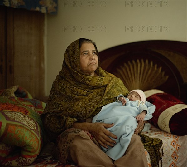 Grandmother holding baby grandson