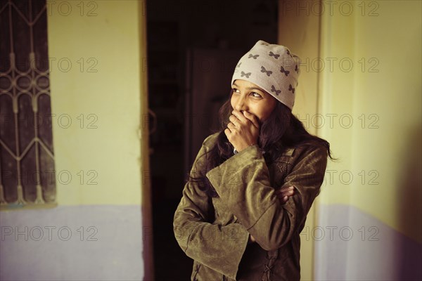 Laughing woman covering her mouth