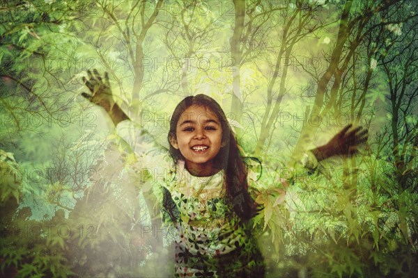 Mixed race girl standing in forest projection