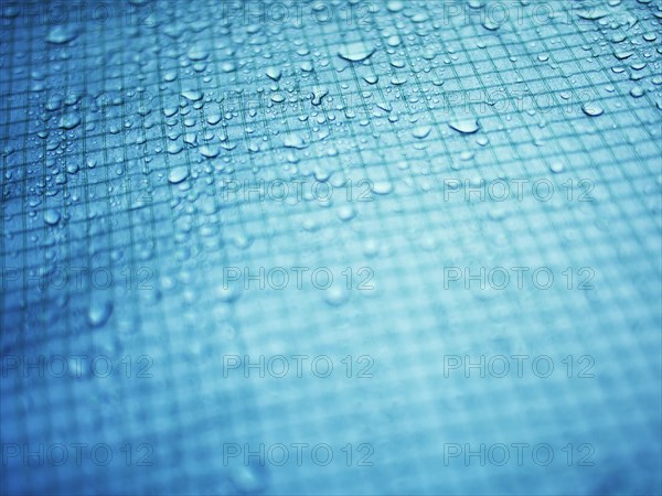 Close up of water droplets on grid surface