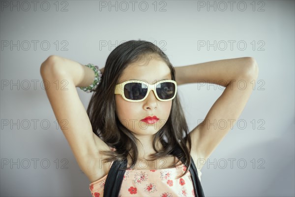 Mixed race girl wearing makeup and sunglasses