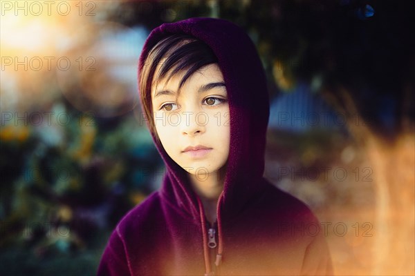 Mixed race girl wearing hoodie outdoors