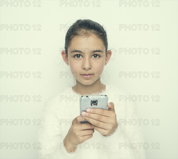 Mixed race girl using cell phone