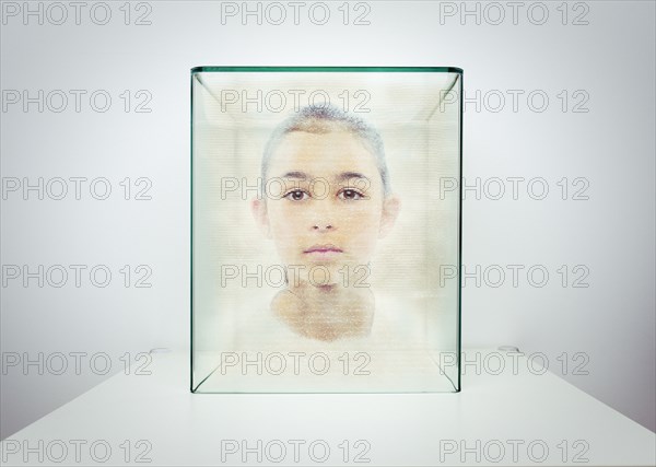 Hologram of Mixed race girl in glass box