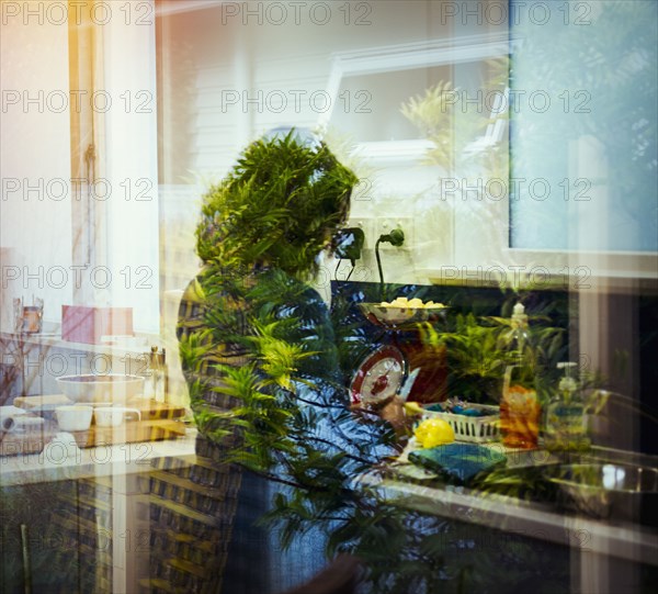 Mixed race woman behind window reflections