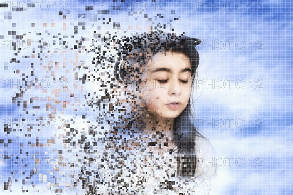 Pixelated mixed race girl dissolving in sky