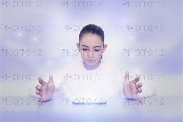 Mixed race girl with glowing digital tablet