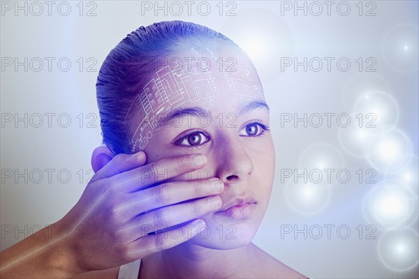 Mixed race girl with technology on her face