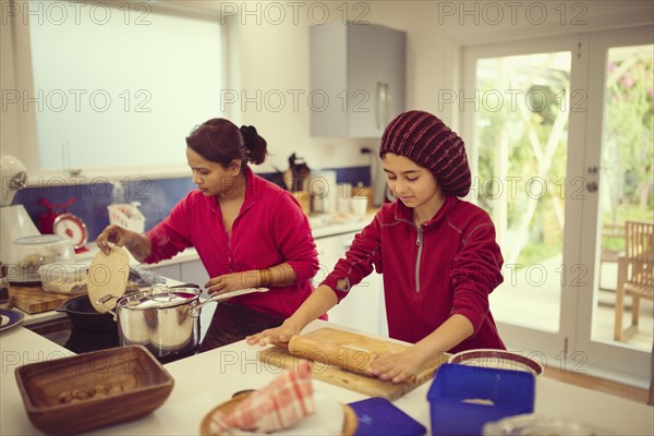 Mother and daughter cooking in kitchen